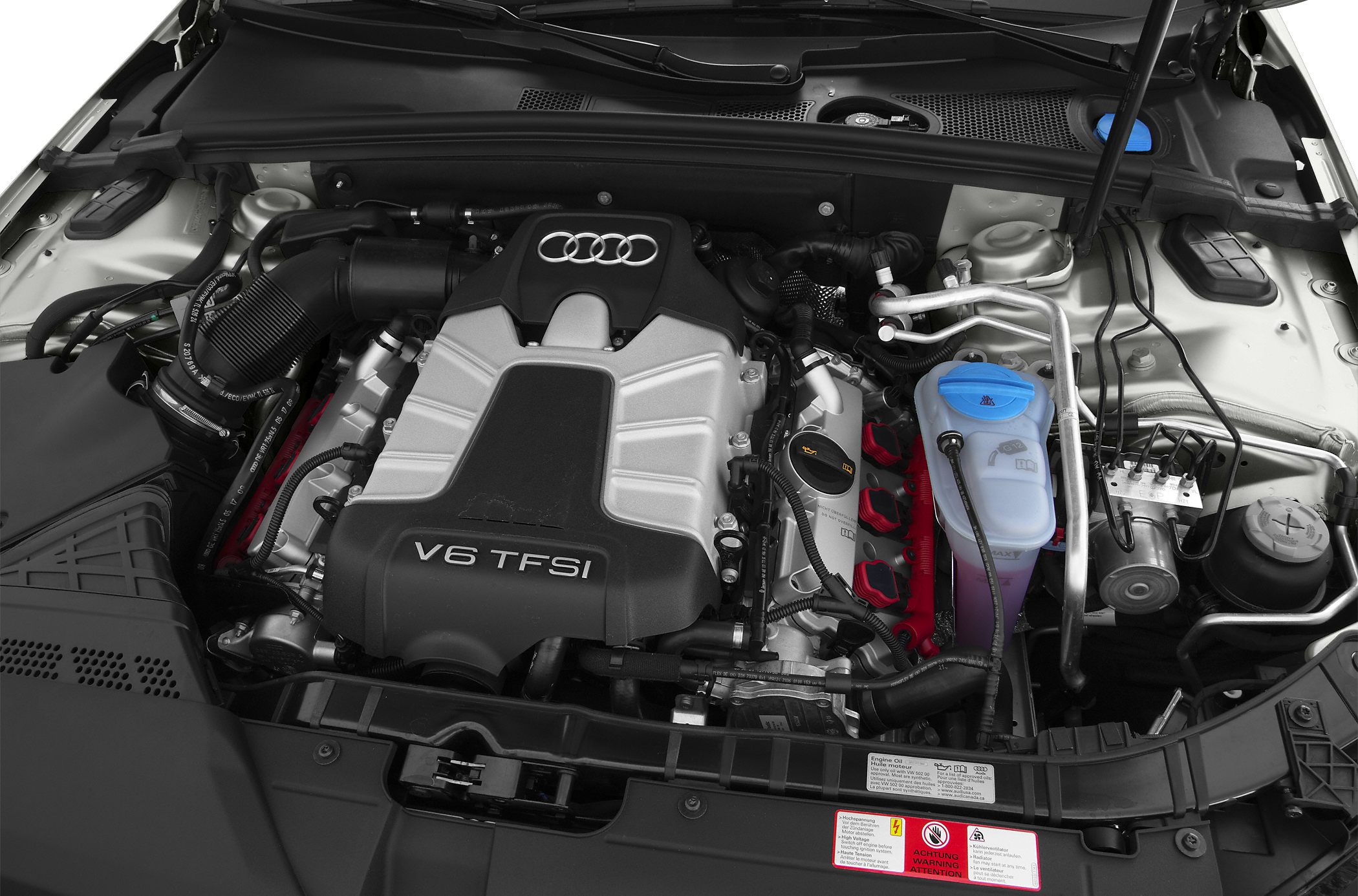 Close-up of V6 TFSI engine bay with visible components and Audi emblem