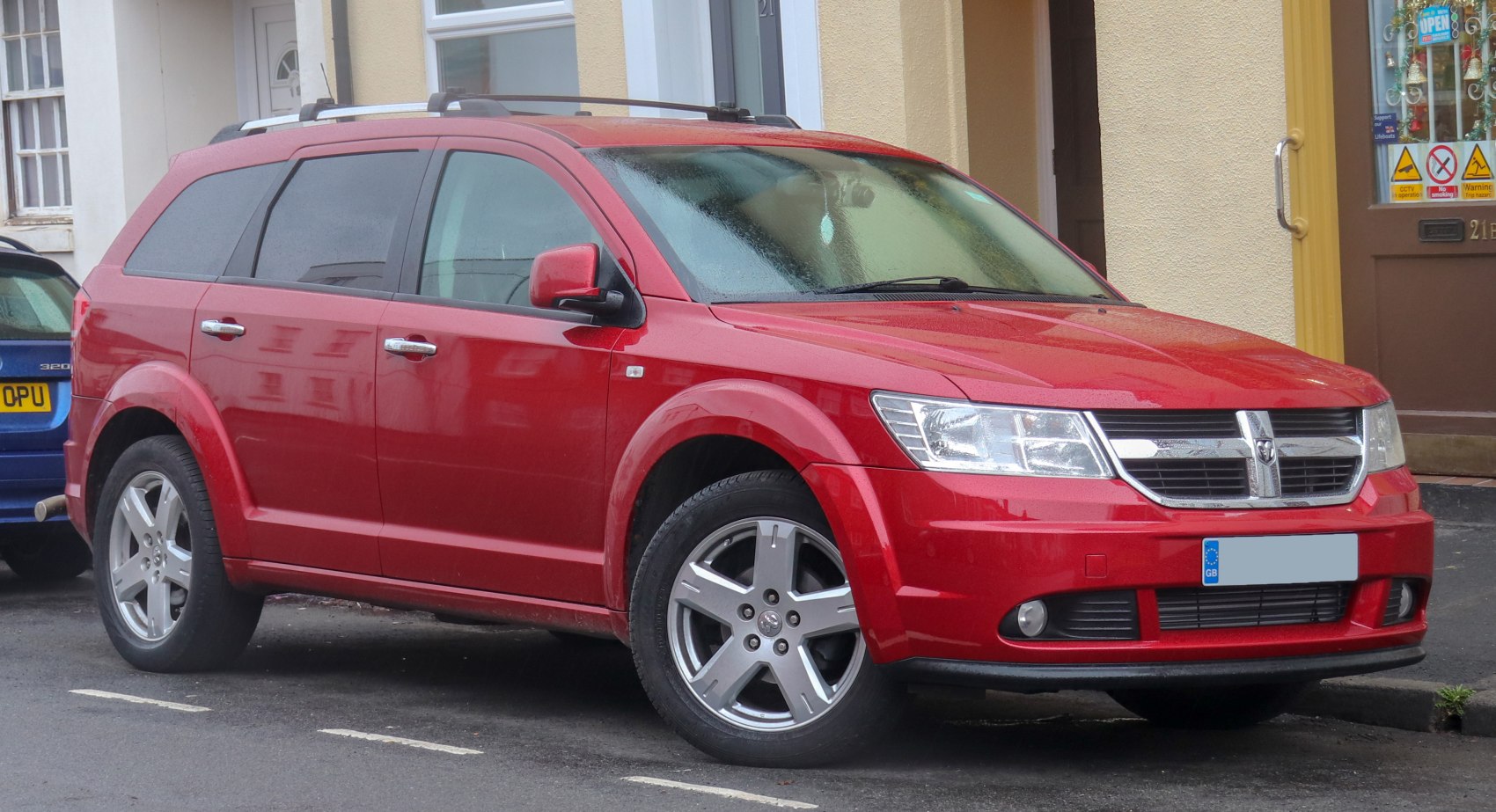 Red SUV with front side view and alloy wheels