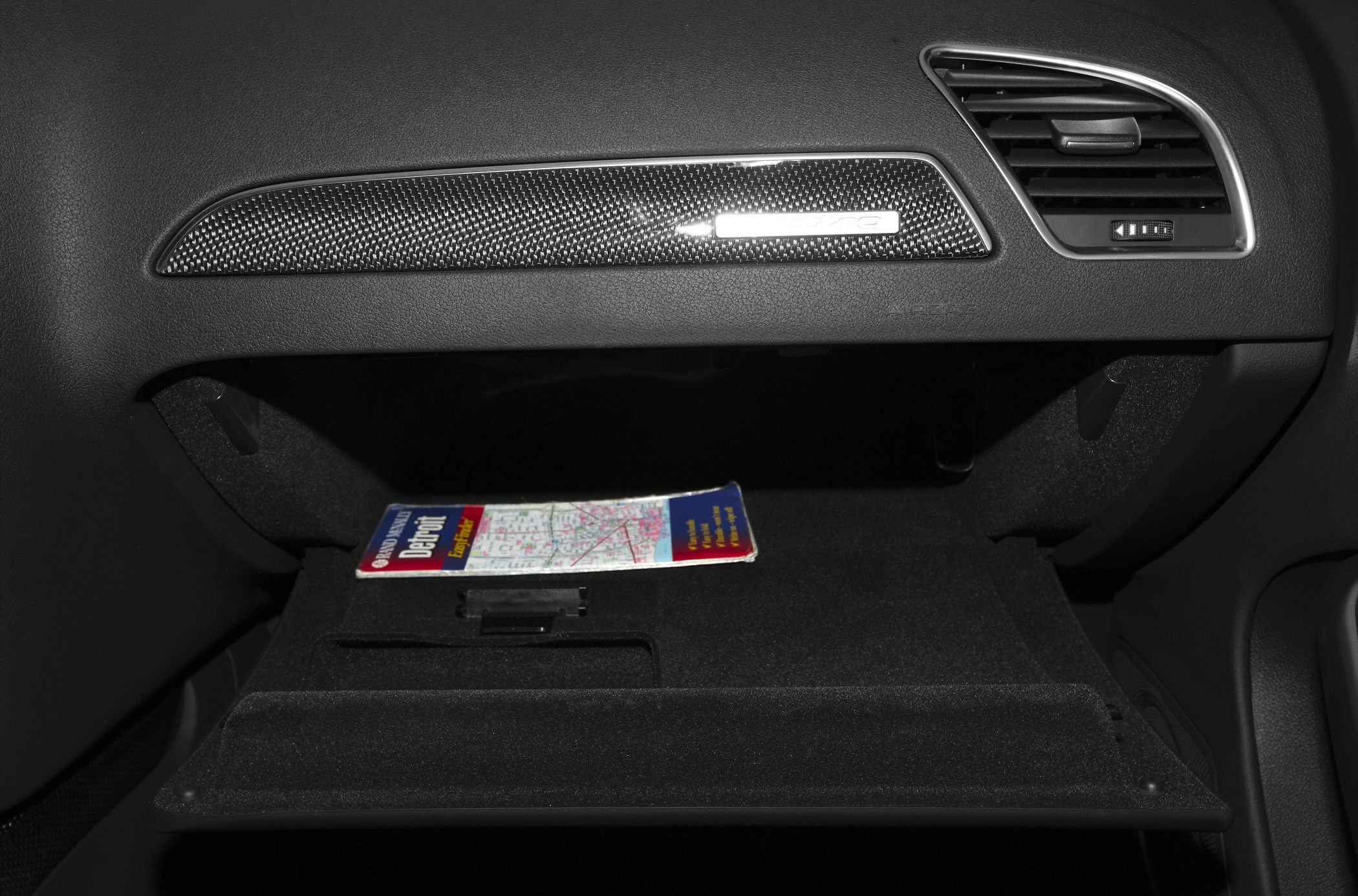 Glove compartment with carbon trim and air vent