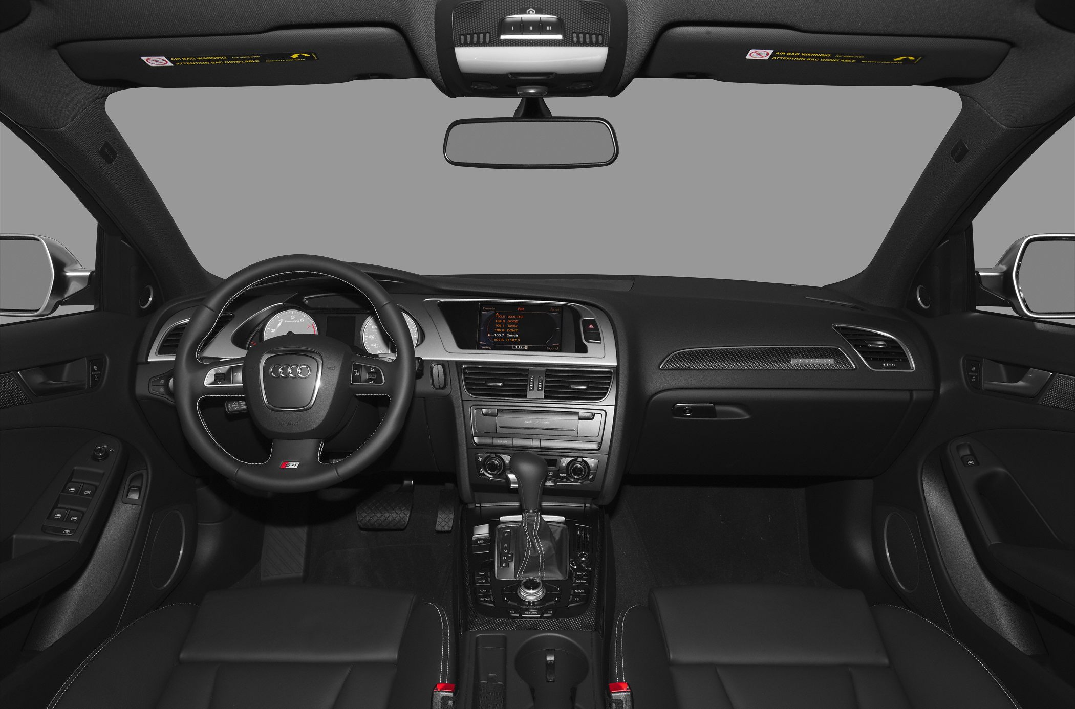 Audi interior showing steering wheel and center console with gear shift