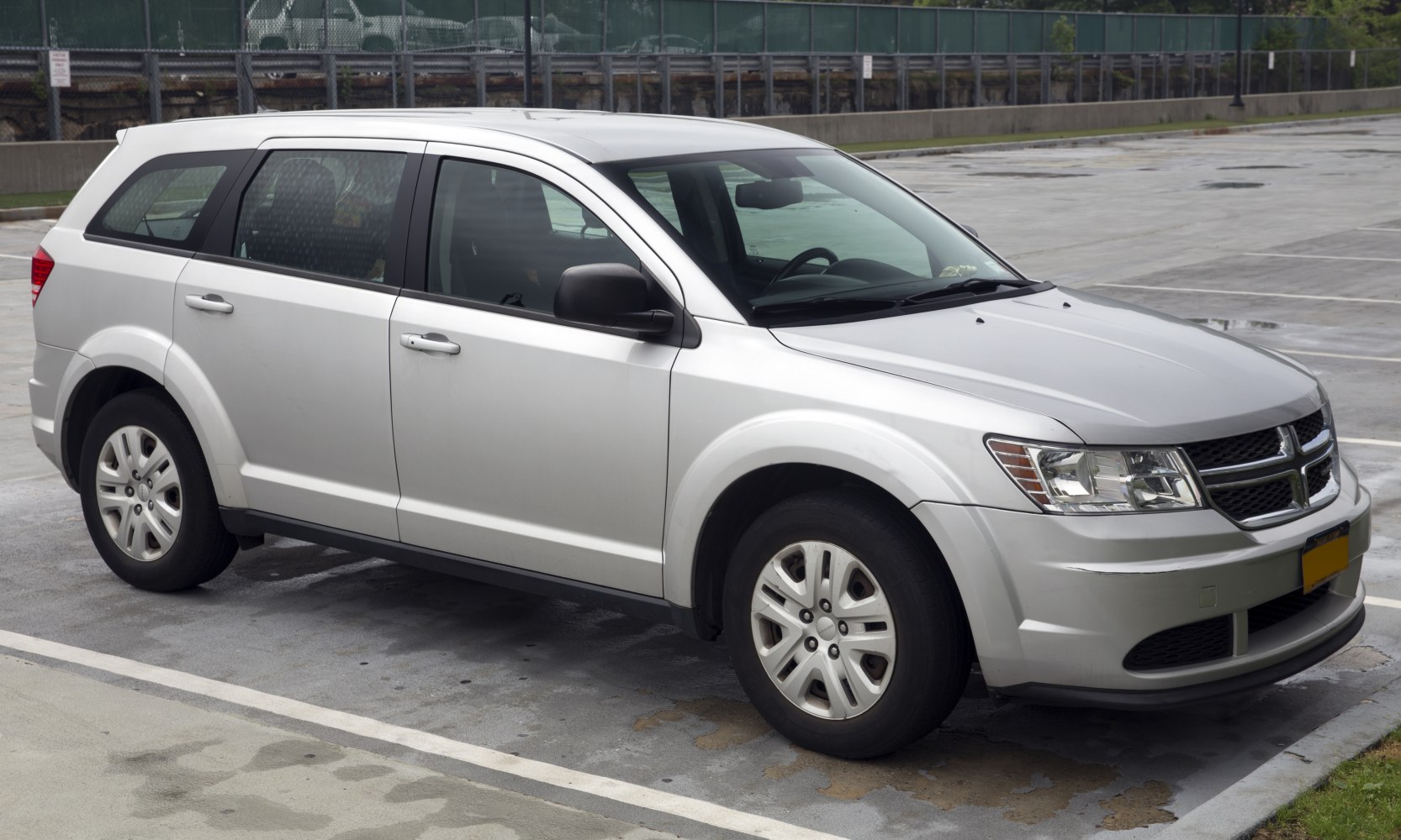 Mid-size SUV front-side view with silver paint and distinctive grille