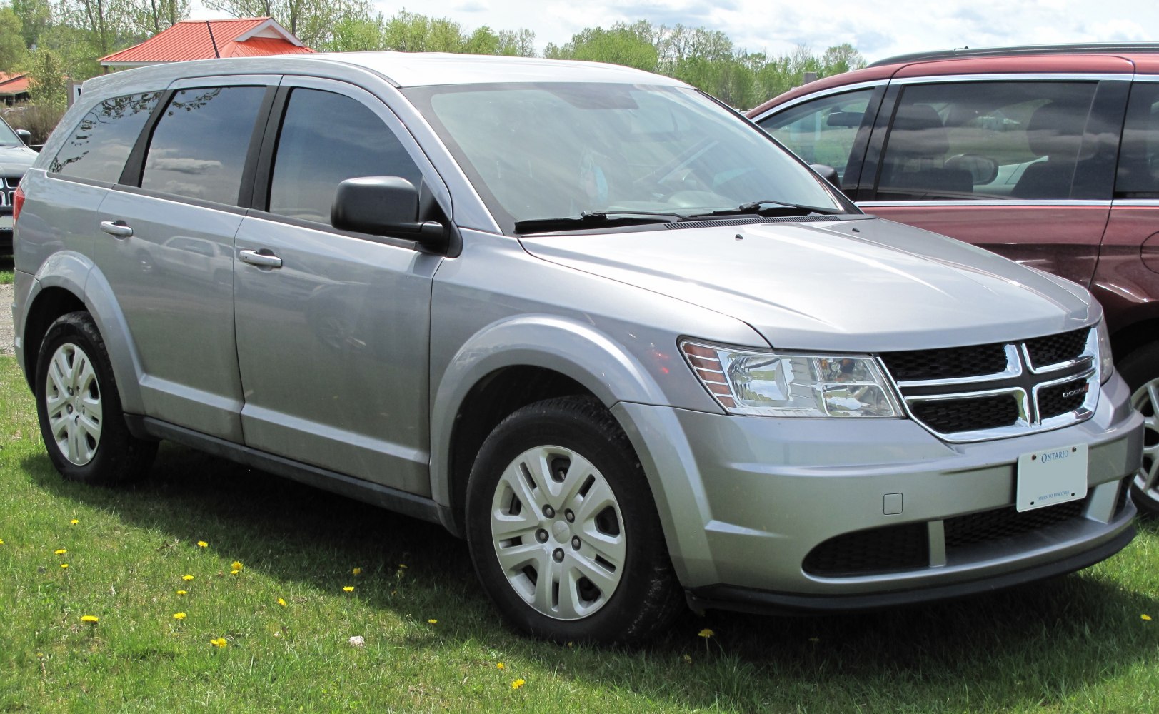 Silver SUV mid-size vehicle front side profile