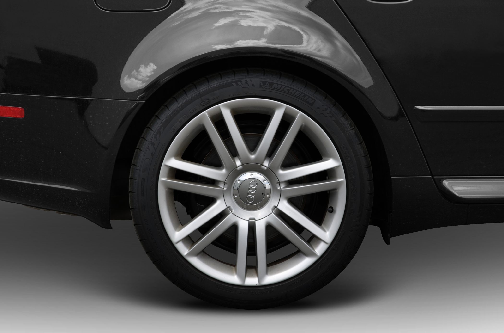 10-spoke alloy wheel with Michelin tire on black car body