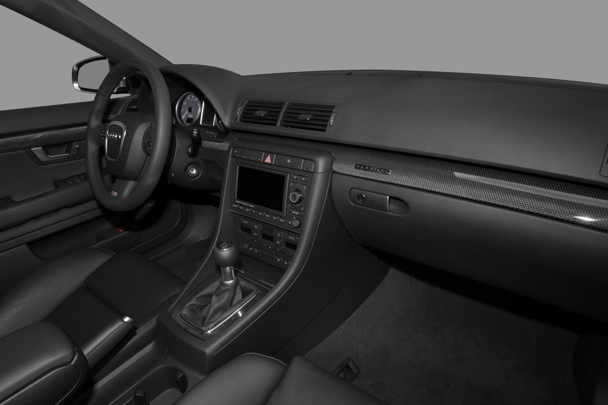 Audi car interior with manual gearshift and carbon fiber dashboard trim