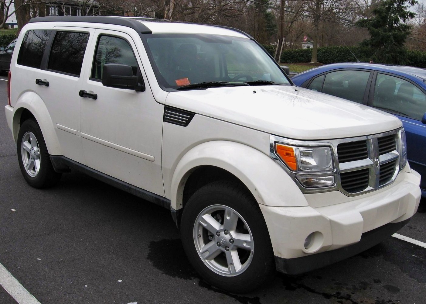 Boxy SUV with chrome grille and five-spoke alloy wheels