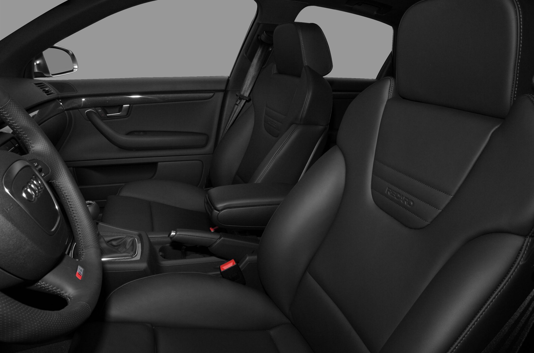 Close-up of black Recaro sport seats and steering wheel interior.