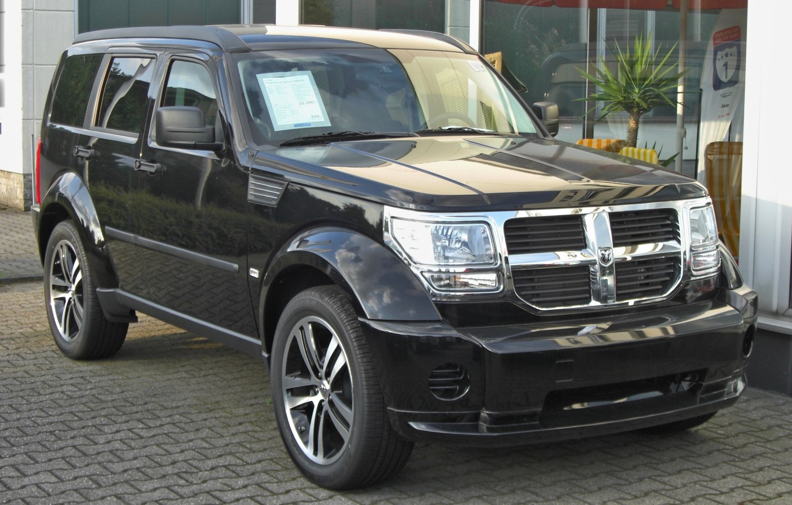 SUV front side with distinctive grille and alloy wheels in black.