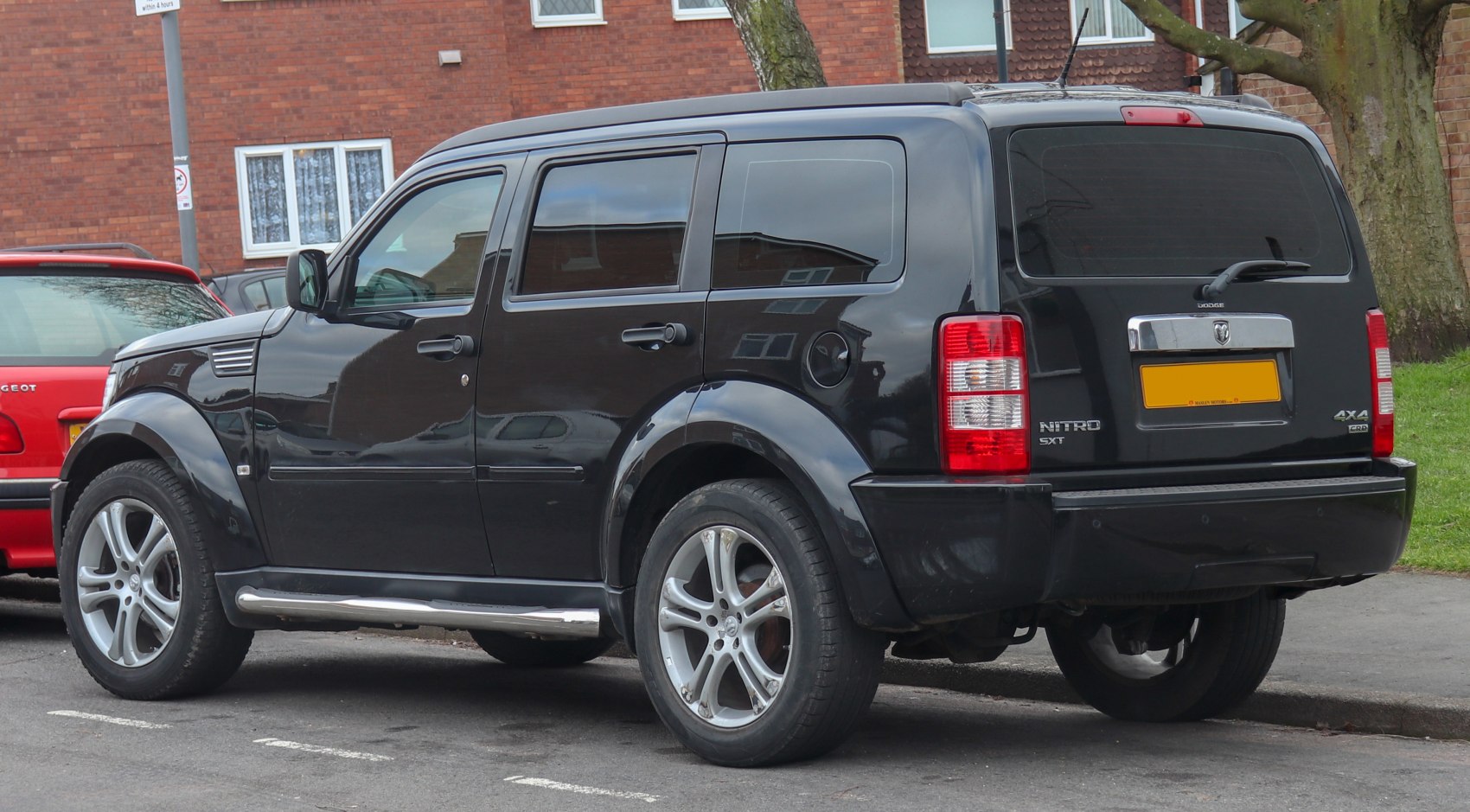 Rear side of black SUV with alloy wheels and tinted windows