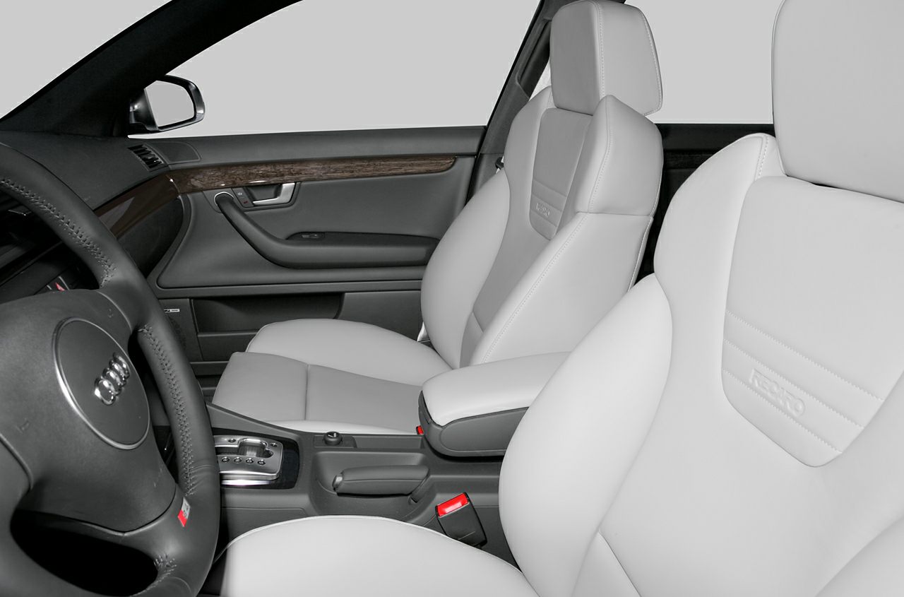 Recaro leather seats and black steering wheel in luxury car interior