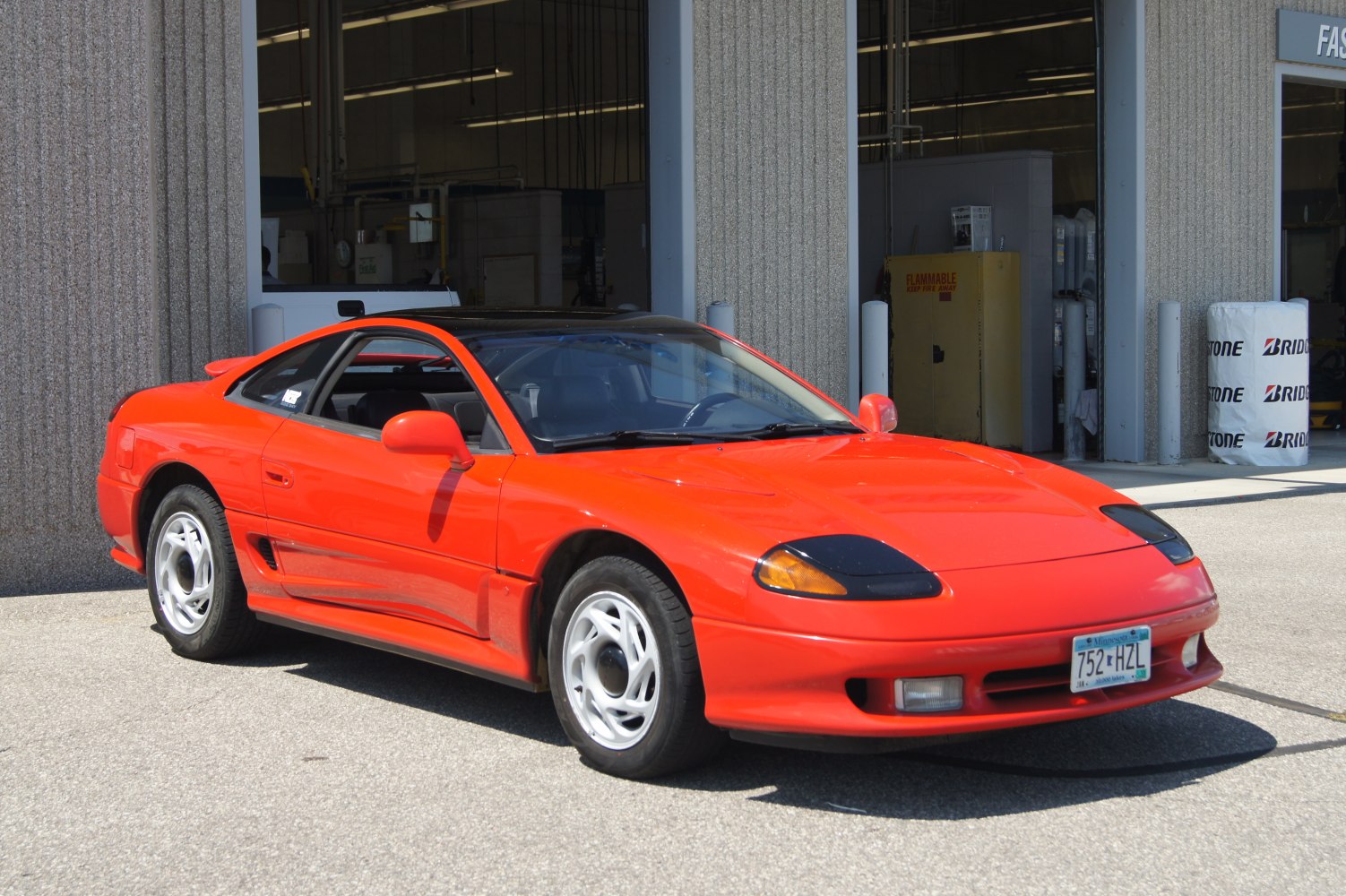 Red sports coupe with pop-up headlights and rear spoiler