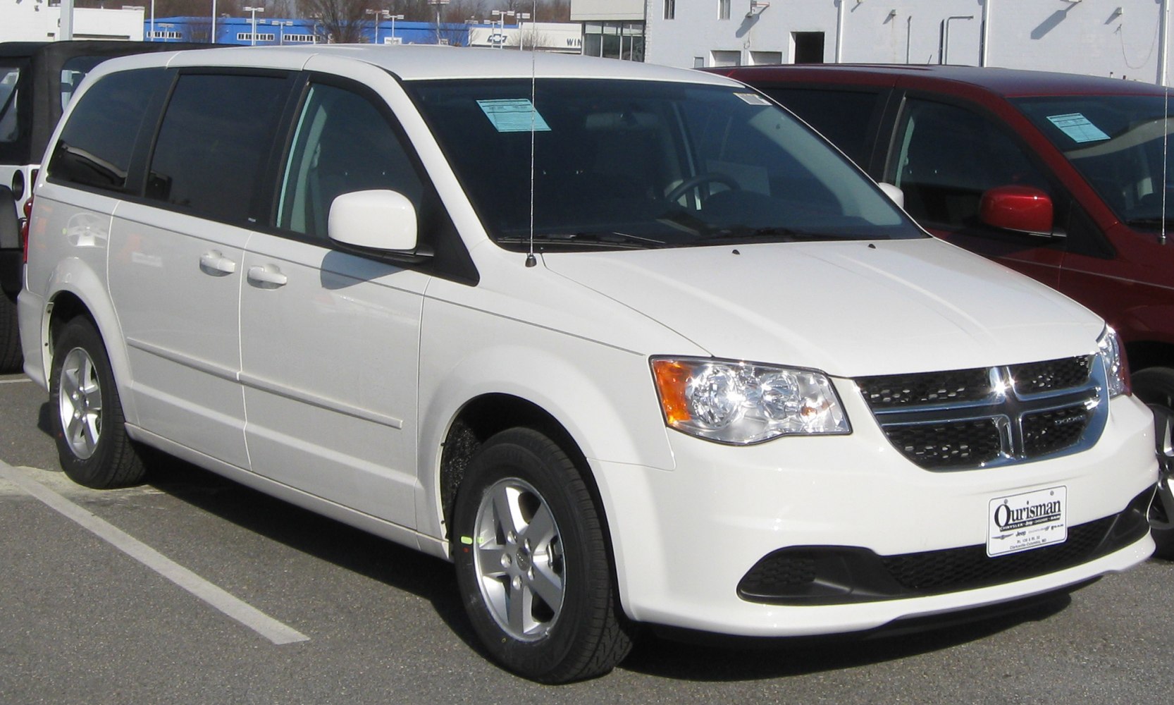 White minivan front three-quarter view with alloy wheels
