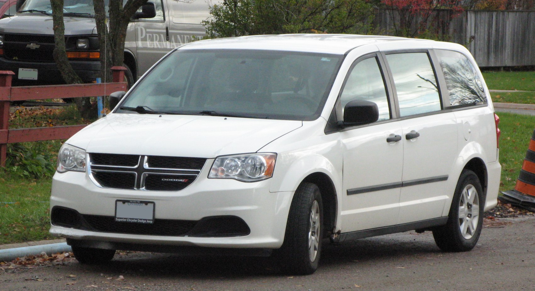 White minivan front view with distinct grille and headlights