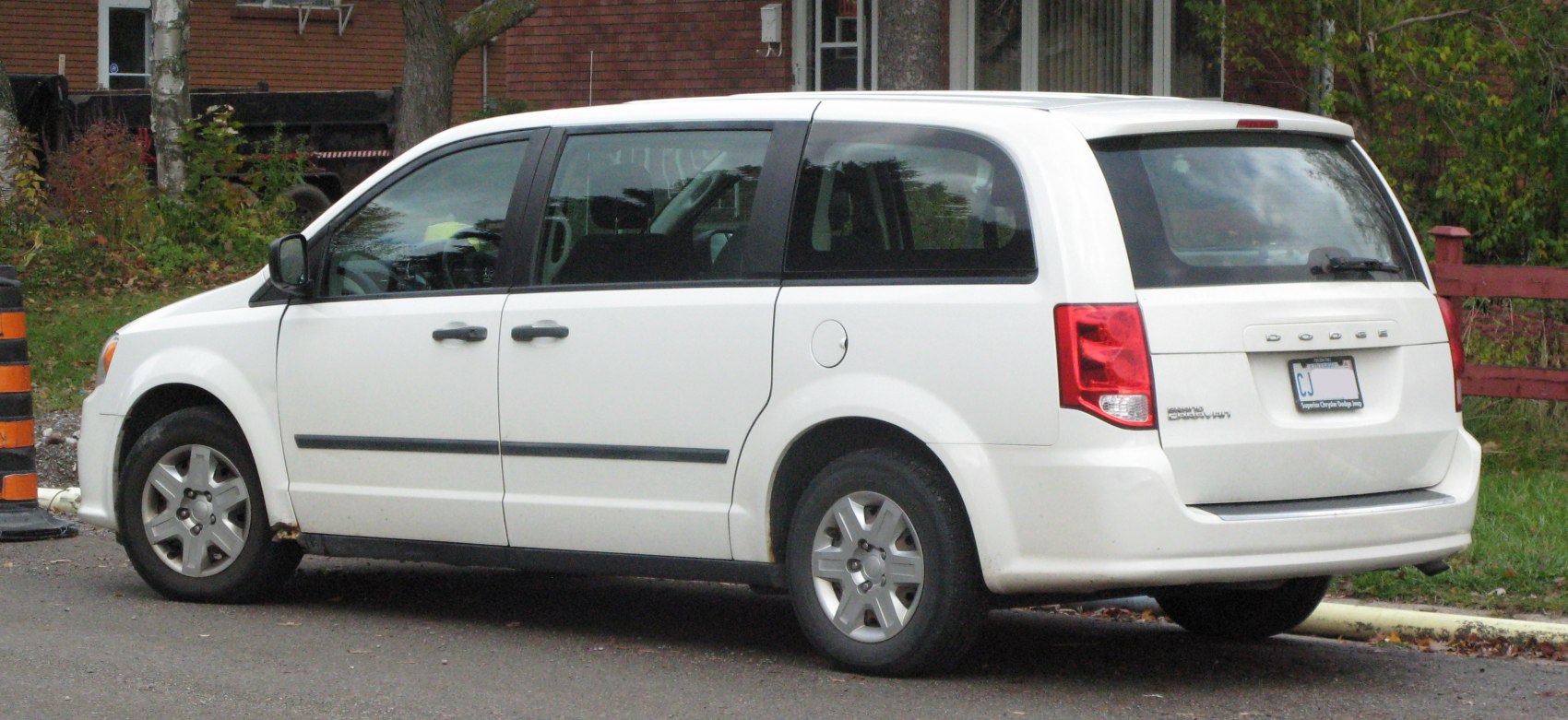 White minivan showing side and rear exterior design features.