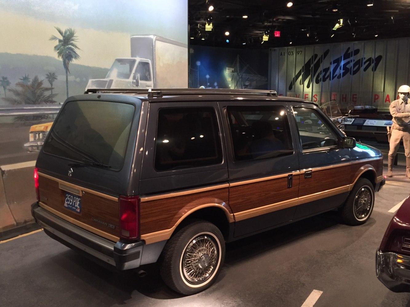 Rear view of minivan with wood paneling and wire-spoke wheels