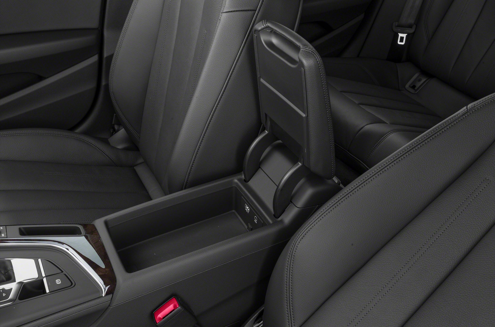 Center console with open storage compartment and black leather seats