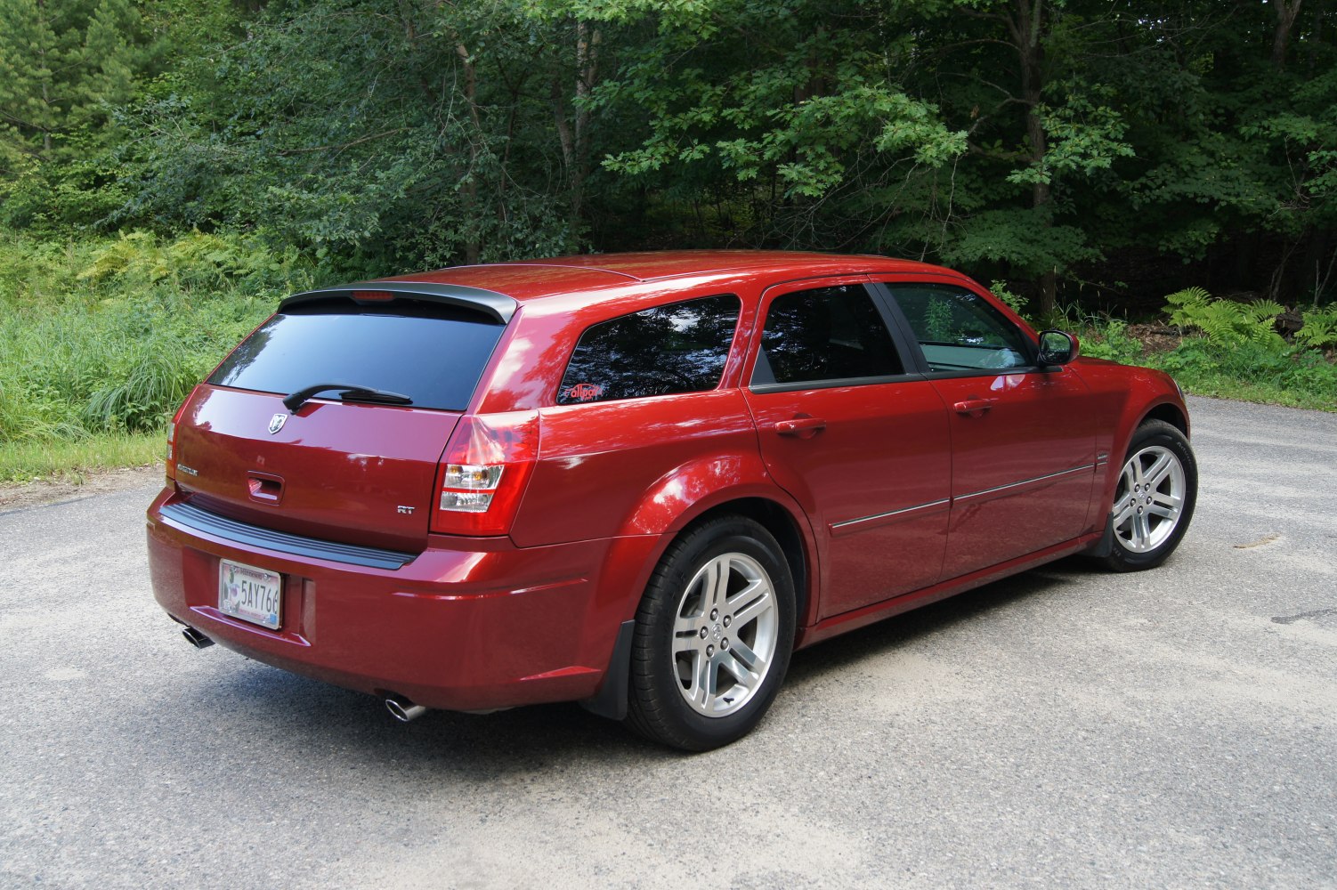 Rear and side view of a sporty station wagon with tinted windows and dual exhausts
