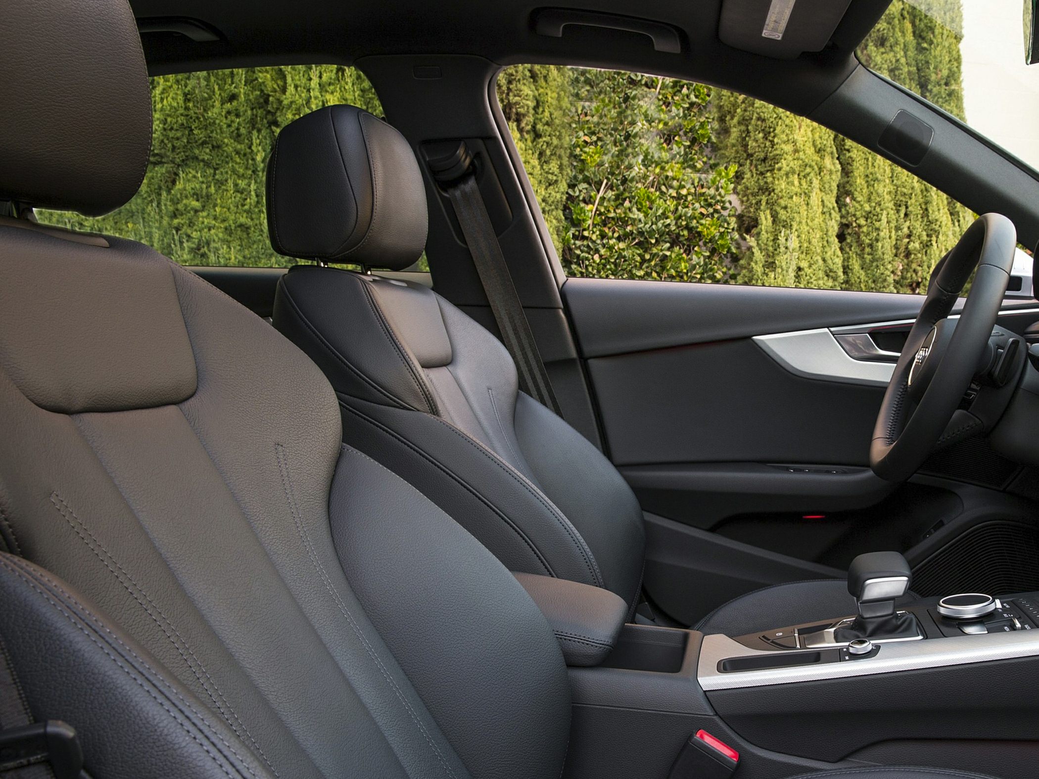 Front black leather seats and dashboard with gear shift and steering wheel