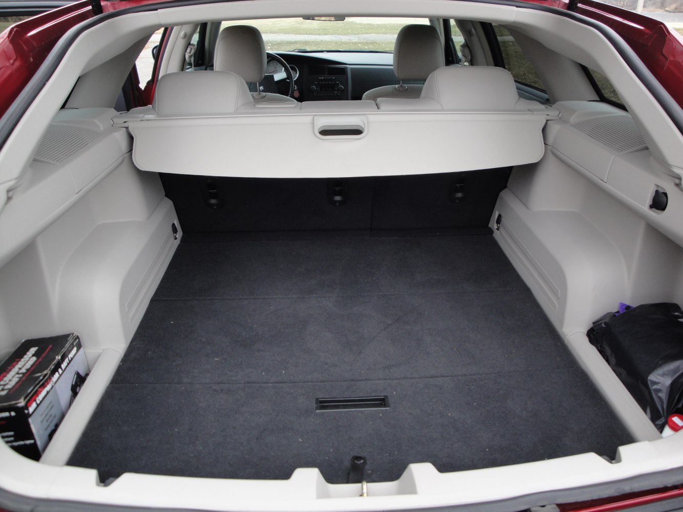 Spacious rear cargo area with protective cover and gray upholstery