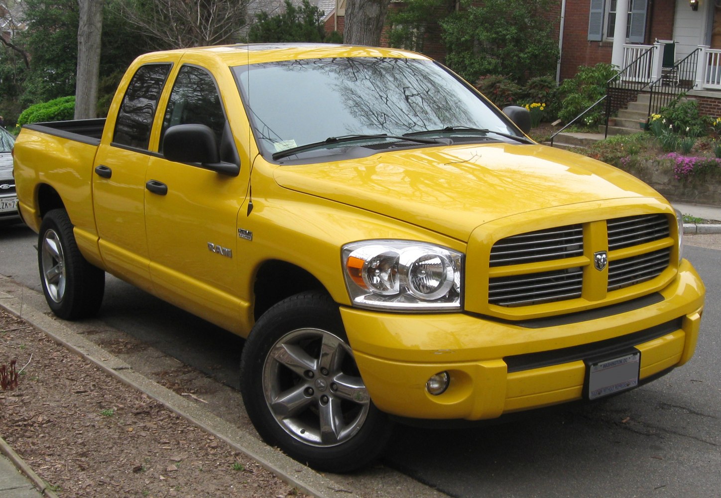 Yellow pickup with quad headlights and chrome wheels