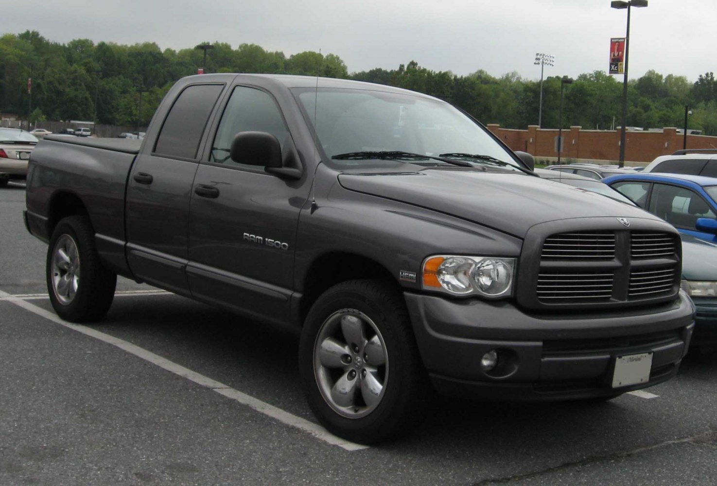 Quad cab pickup truck front three-quarter view with prominent grille and alloy wheels