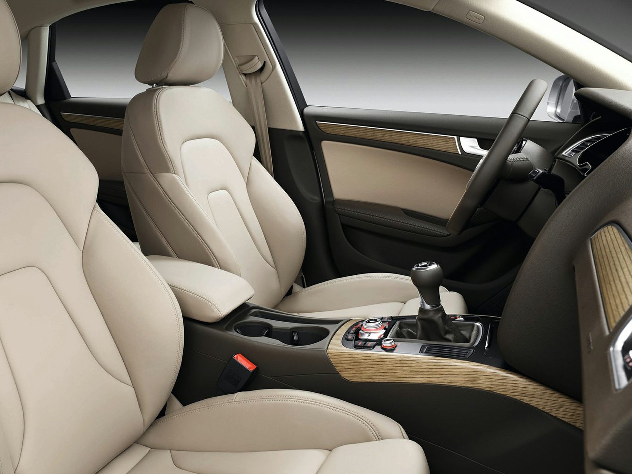 Beige leather seats with wood trim and manual gearshift interior