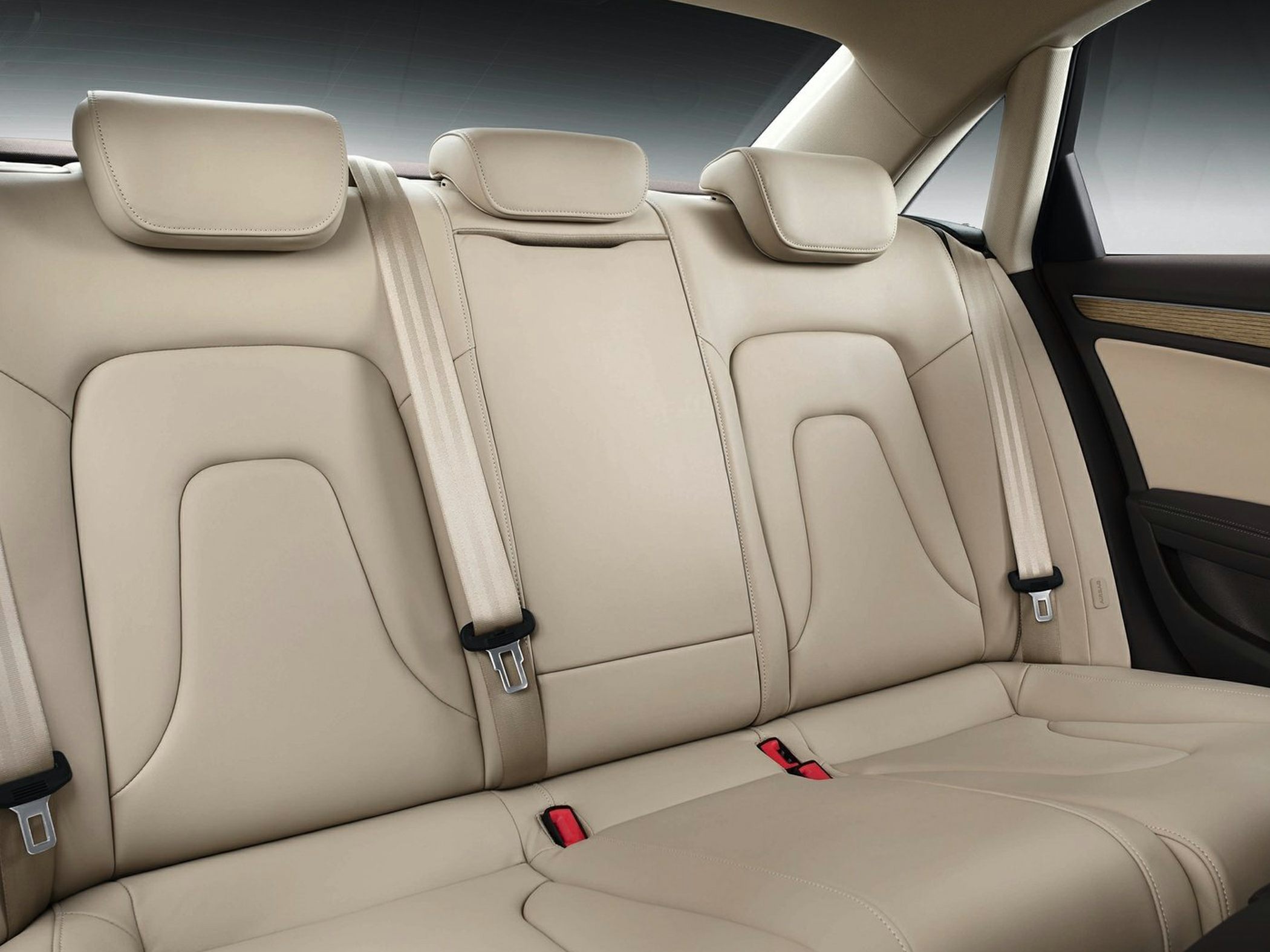 Beige leather rear seats with headrests and seatbelts
