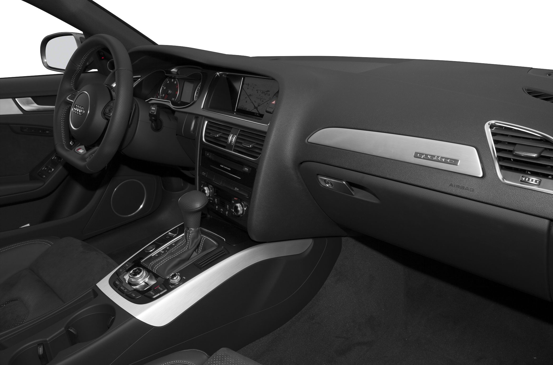 Car interior with dashboard, infotainment system, quattro badge, and gear shift