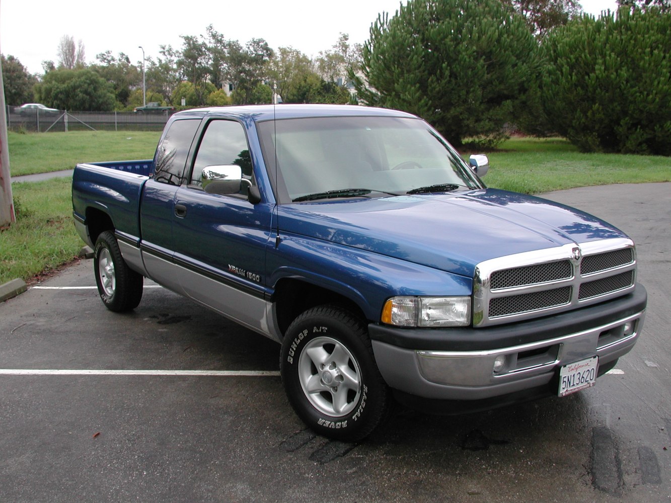 Front-side view of classic pickup with chrome grille and off-road tires