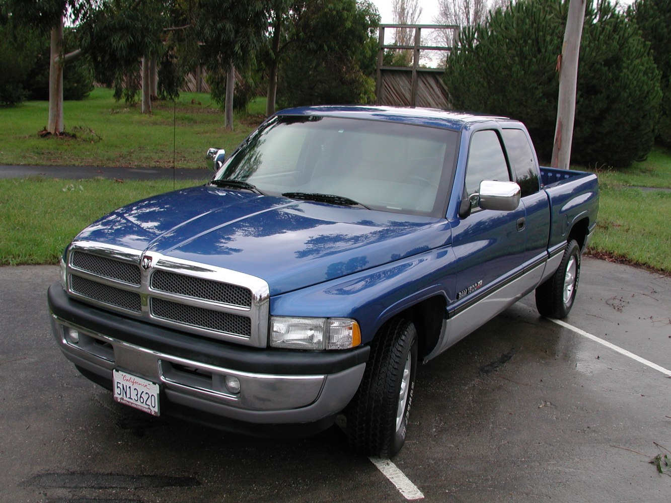 Blue short bed pickup with club cab and chrome grille