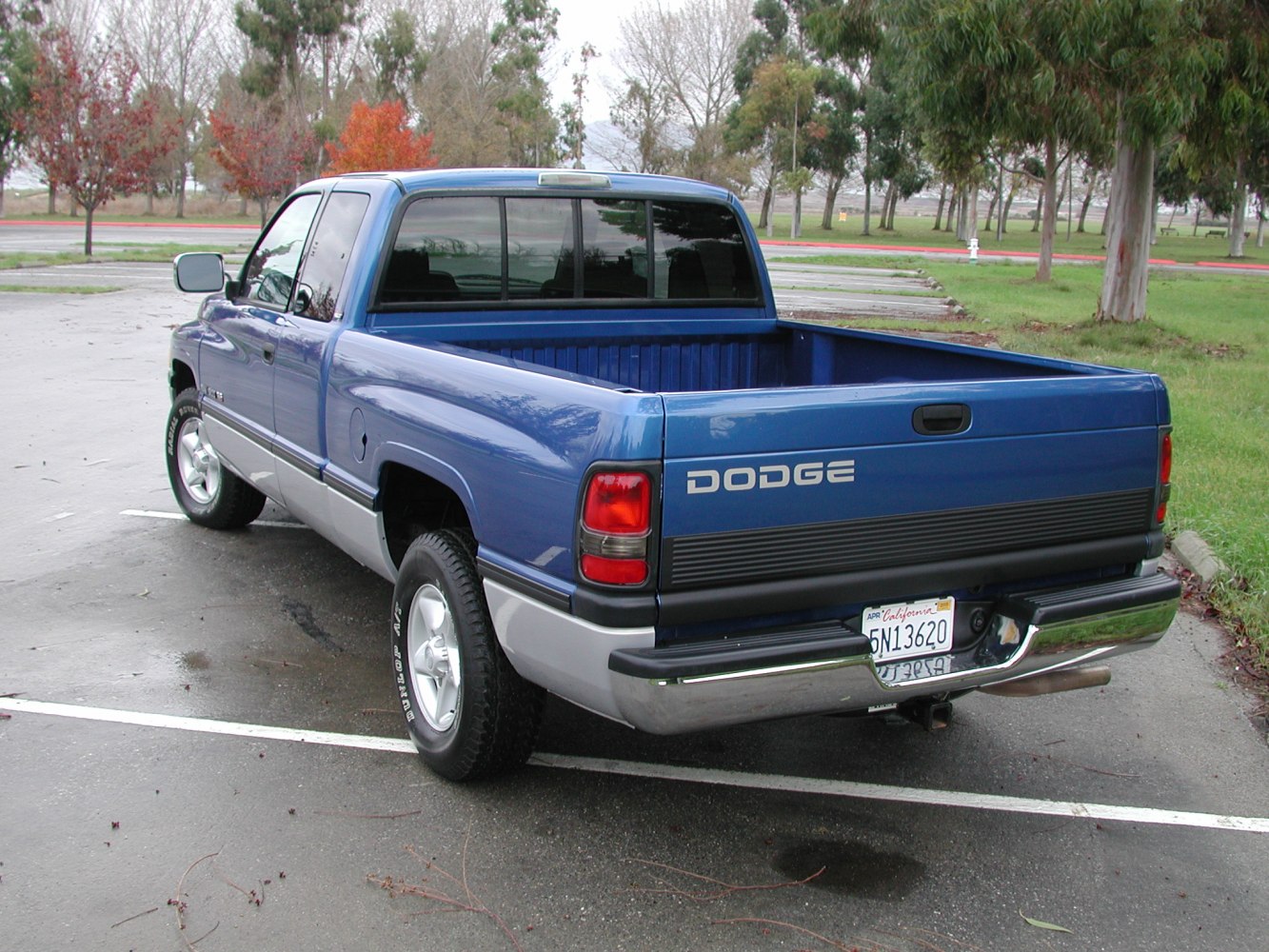 Rear view of a classic blue pickup with short truck bed and club cab design