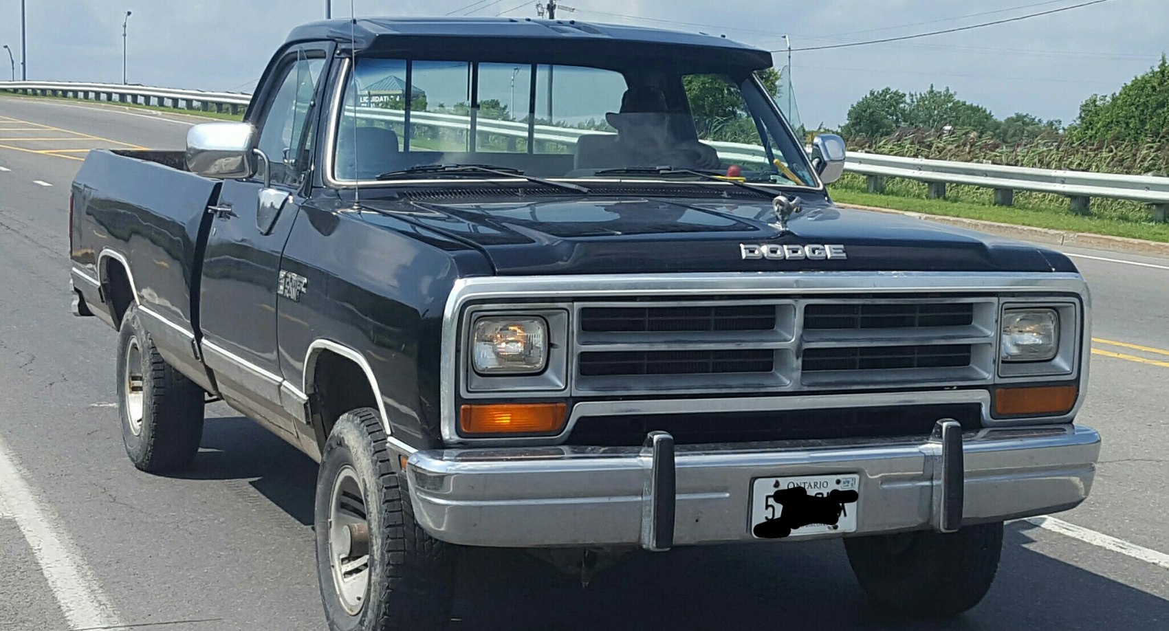 Front view of pickup truck with rectangular headlights and chrome bumper