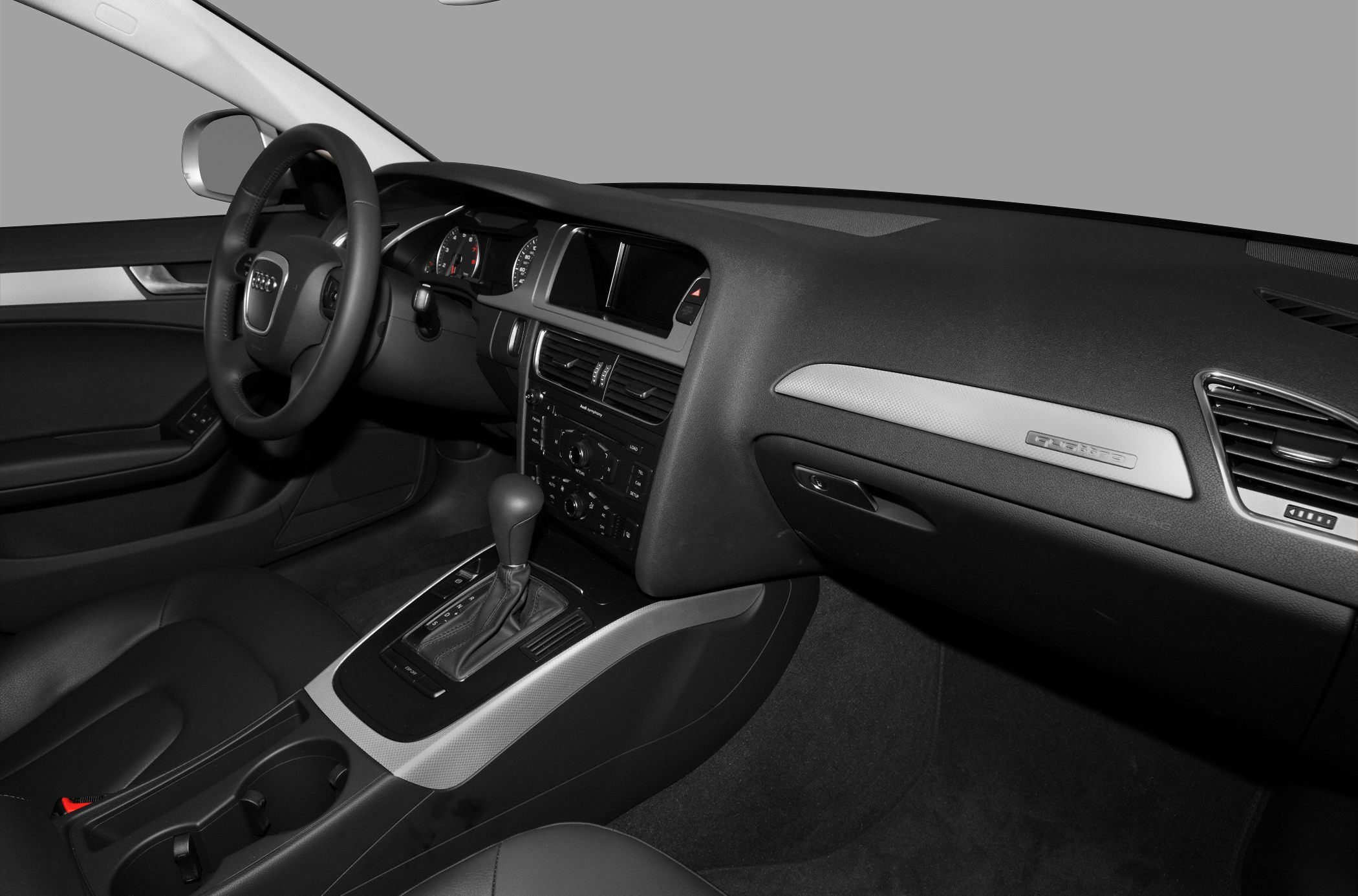 Dashboard, steering wheel, and gear shift of a car interior