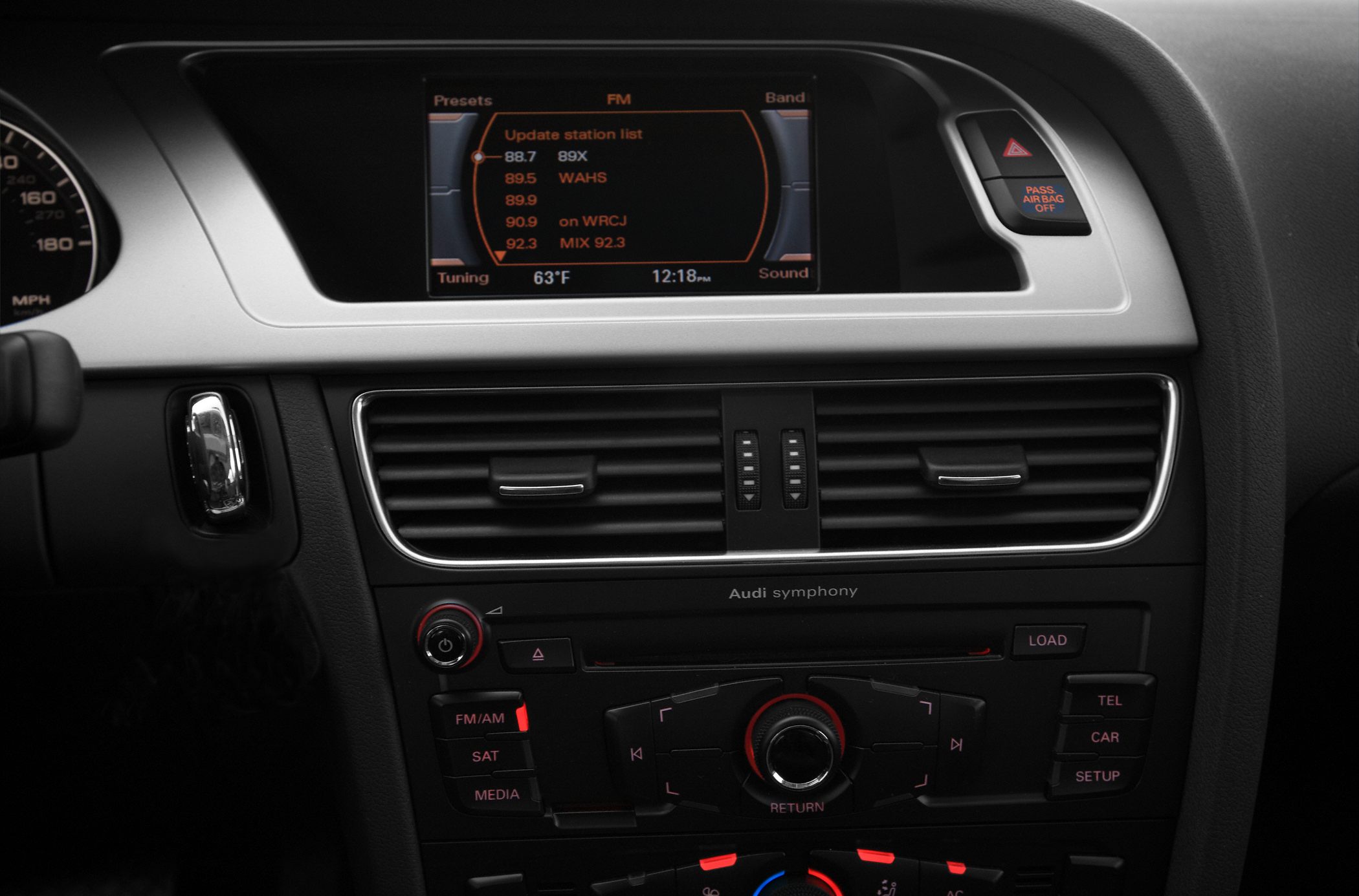 Infotainment screen and dashboard controls with central air vents