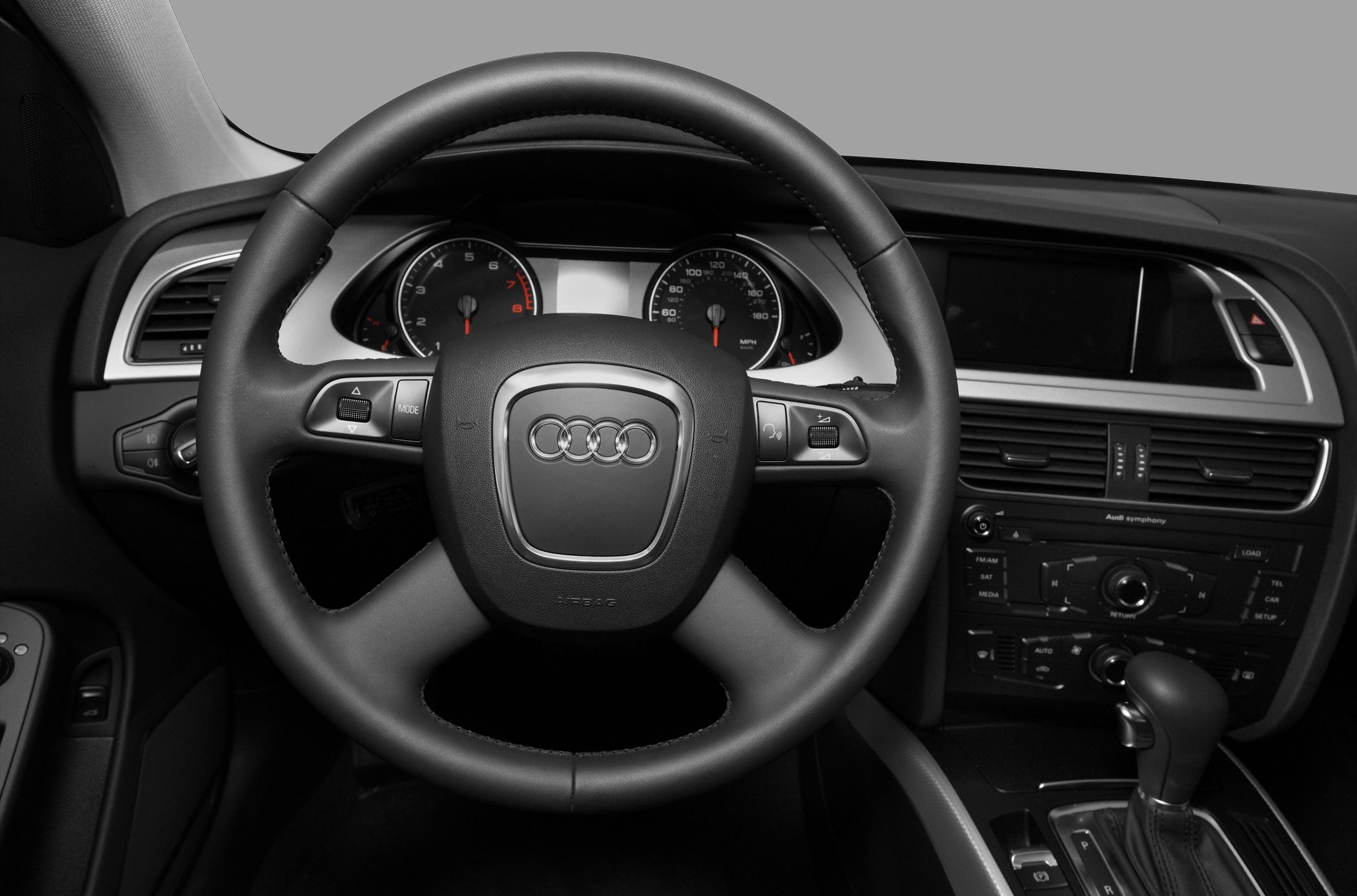 Steering wheel and dashboard with controls and infotainment system