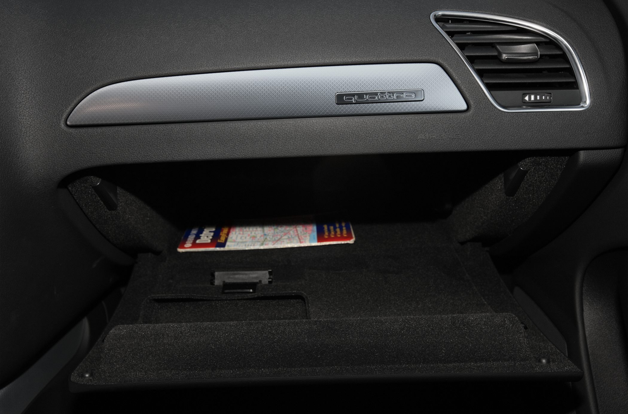 Open glove compartment and dashboard vent with Quattro badge
