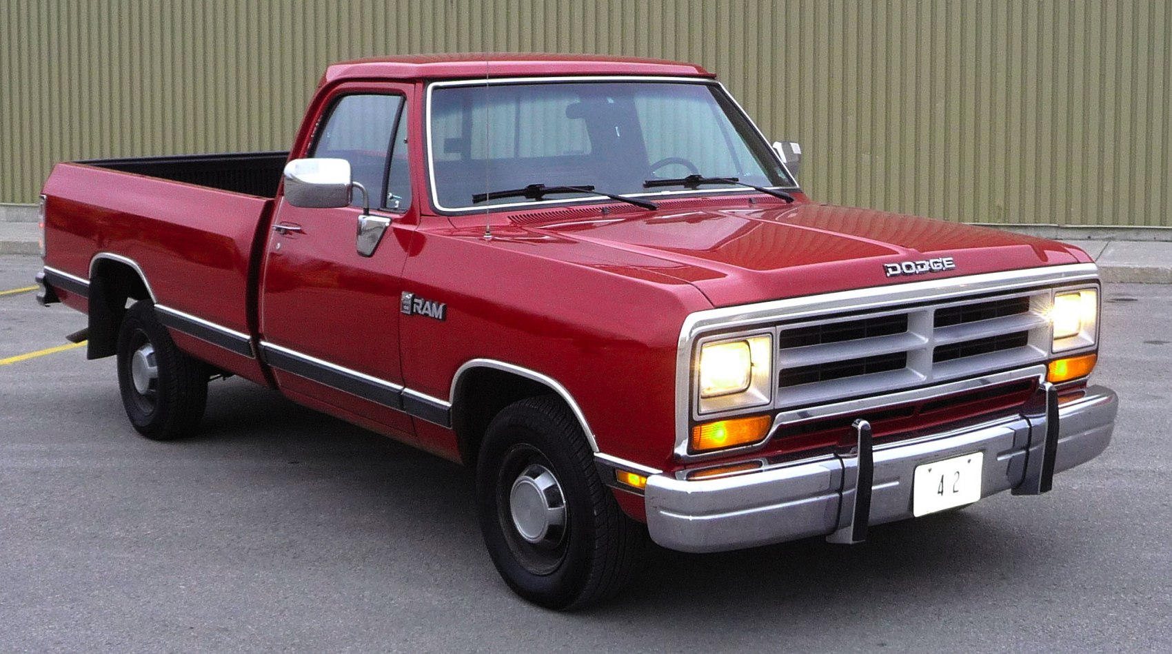 Red pickup truck with rectangular headlights and conventional cab design