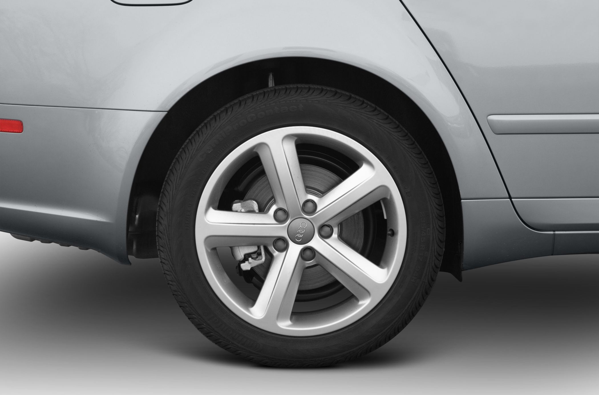 Alloy wheel rim and brake disc close-up with visible brake caliper.