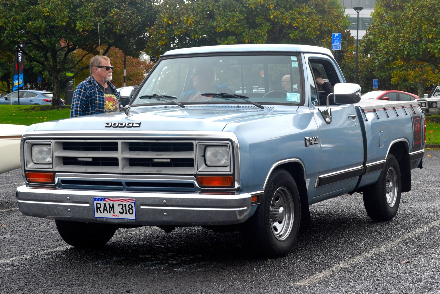 Front grille, rectangular headlights, and side profile of a conventional cab pickup.