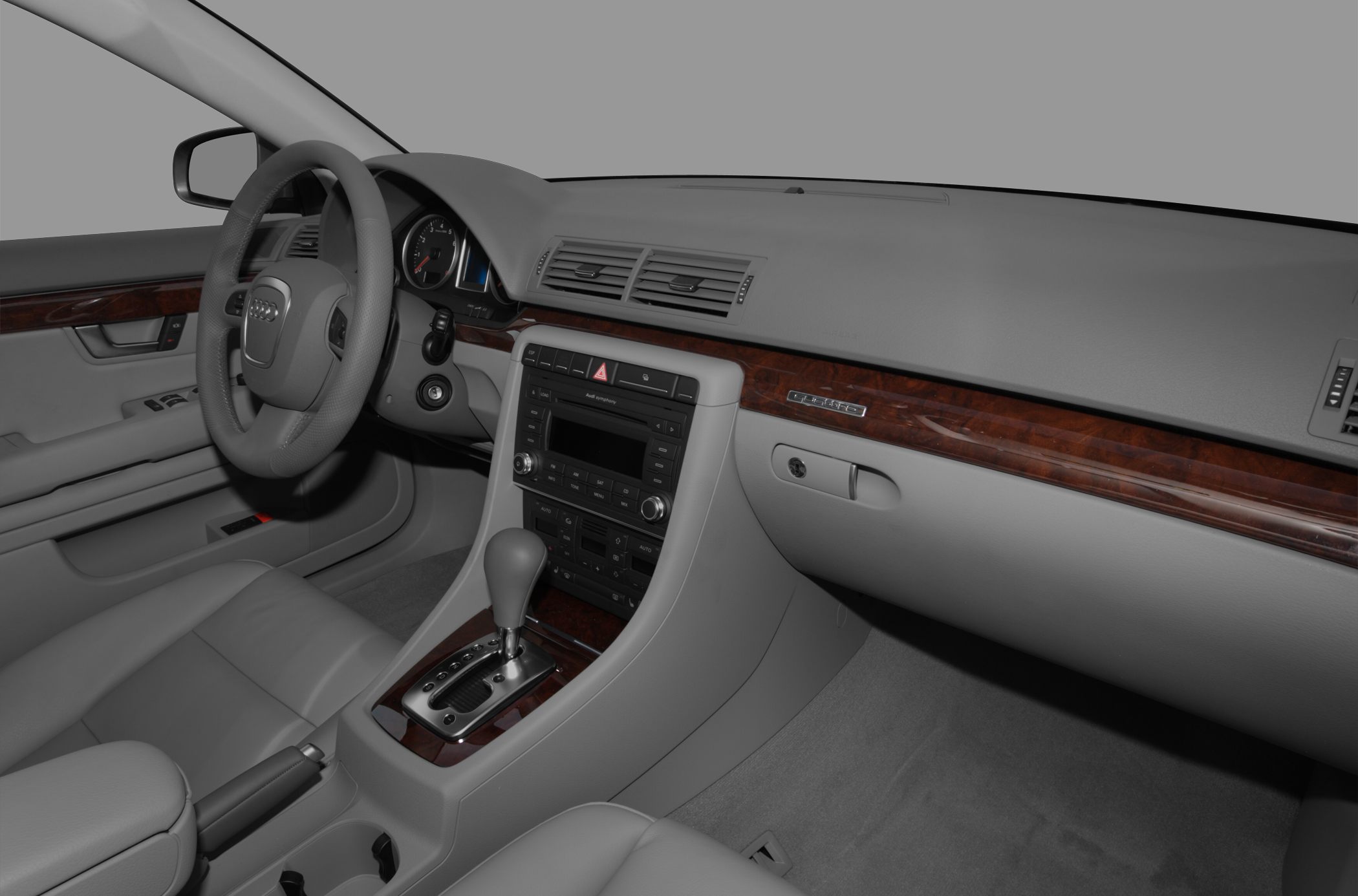 Luxury interior with wood trim, steering wheel, and automatic gear shift