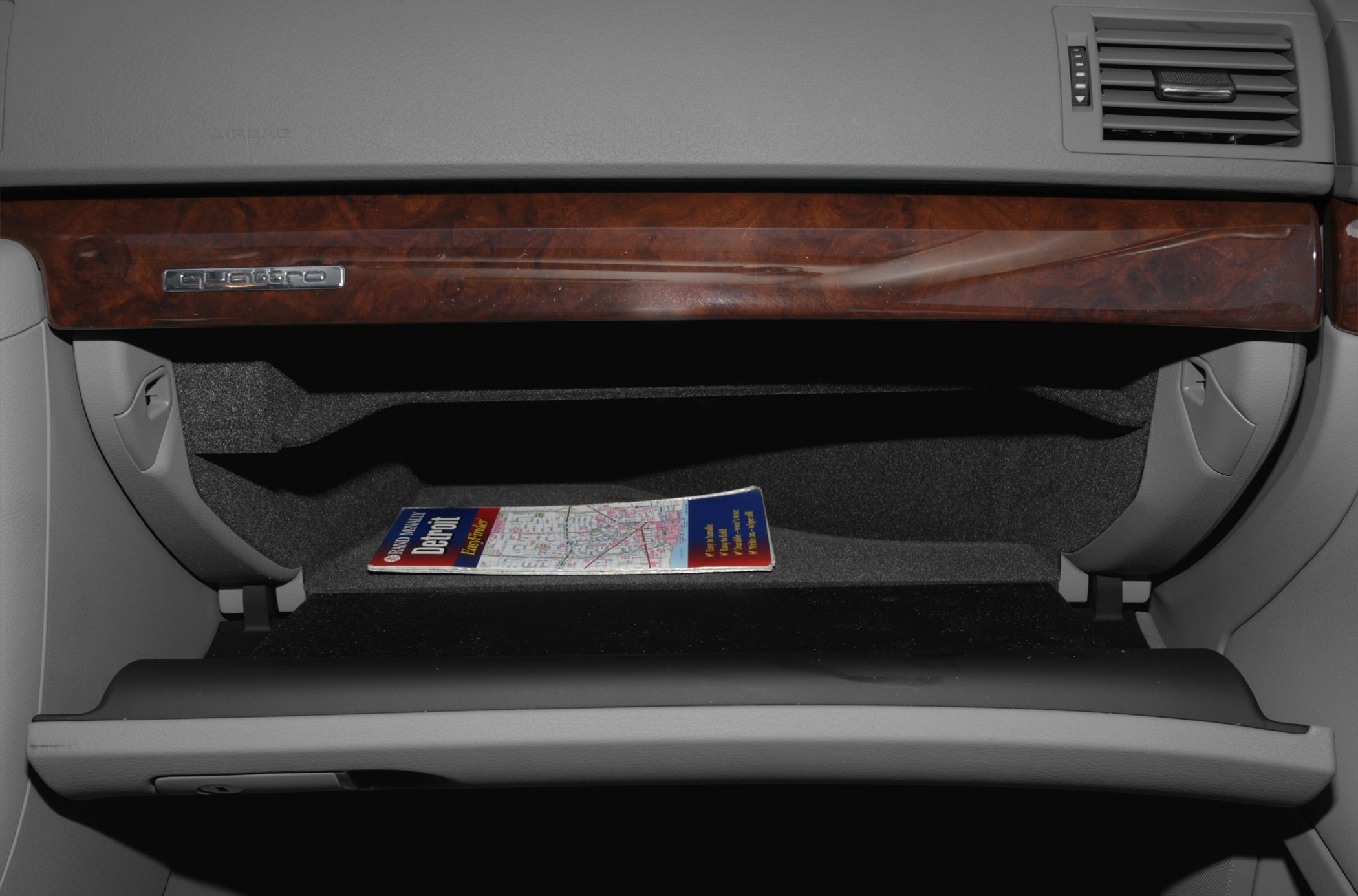 Open glove compartment with wooden trim and Quattro badge