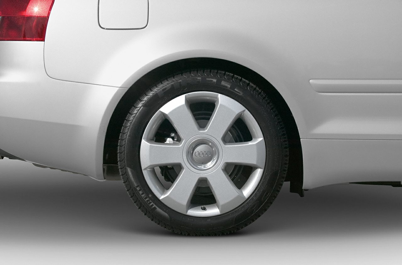 Close-up of alloy wheel and rear quarter panel with fuel door.