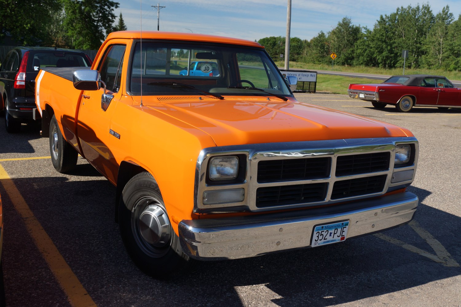 Bright orange pickup with square headlights and chrome bumper