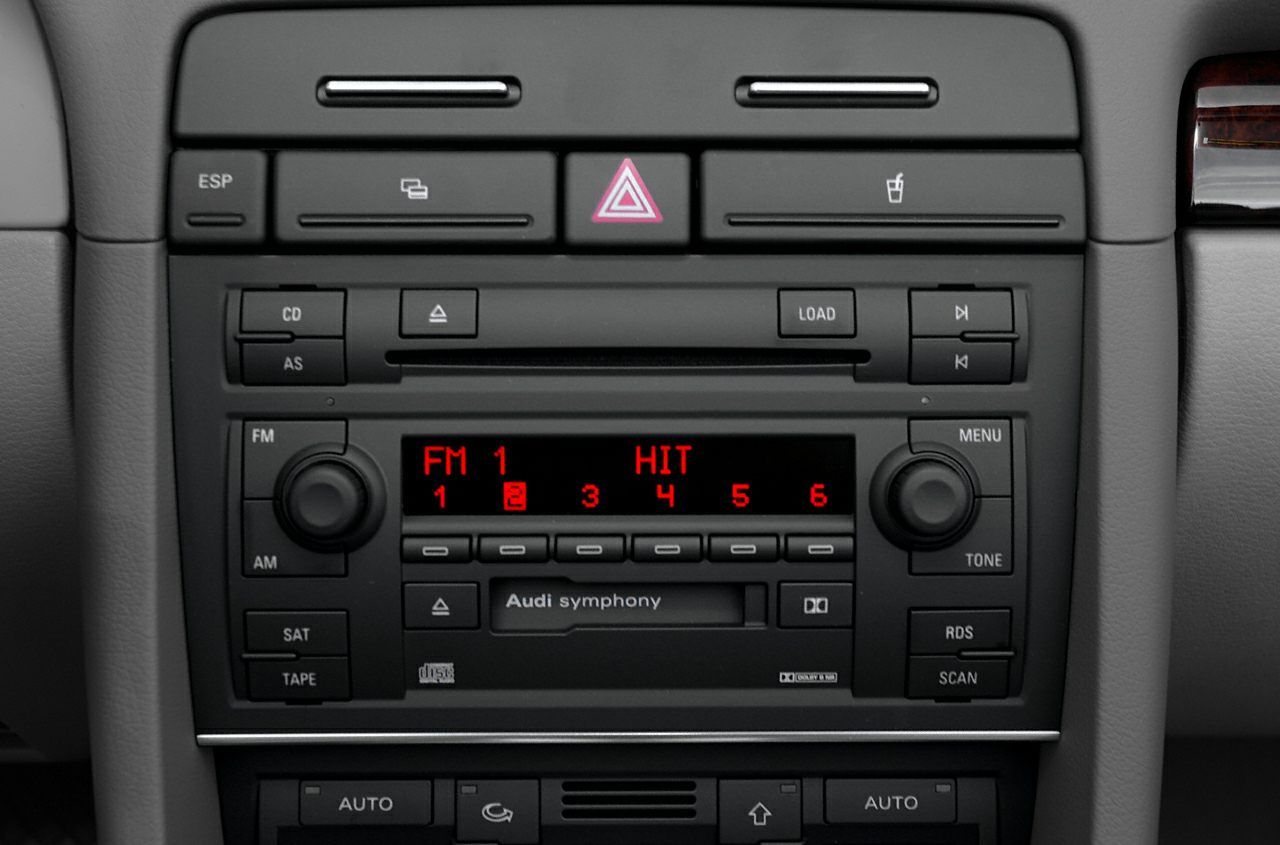 Classic car stereo panel with FM, CD, tape, and control buttons