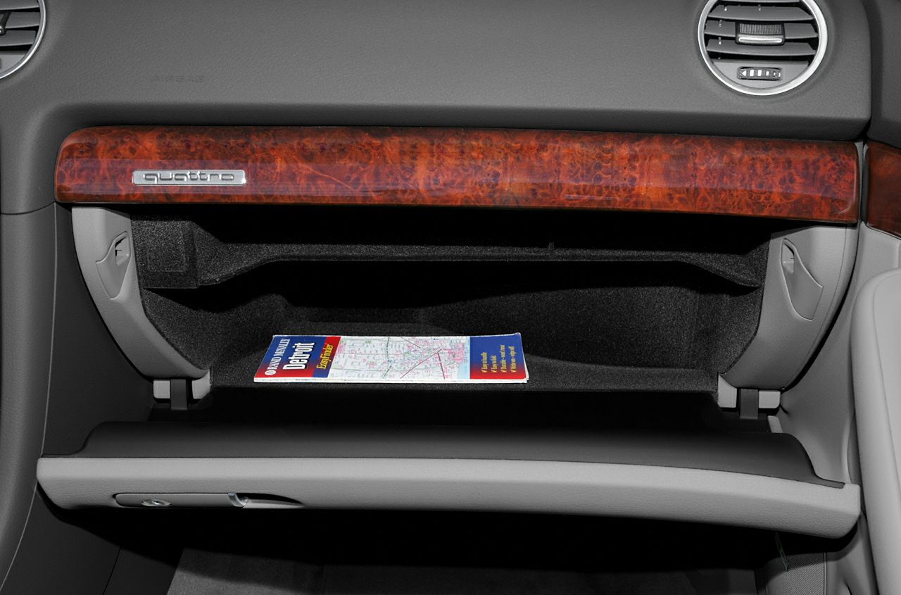 Open glove compartment with wood trim and quattro badge