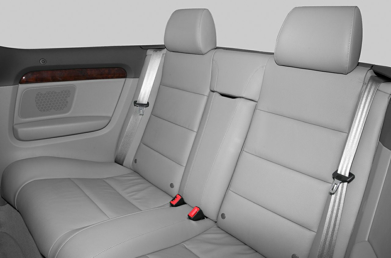 Leather rear seats with seat belts and wood trim panel