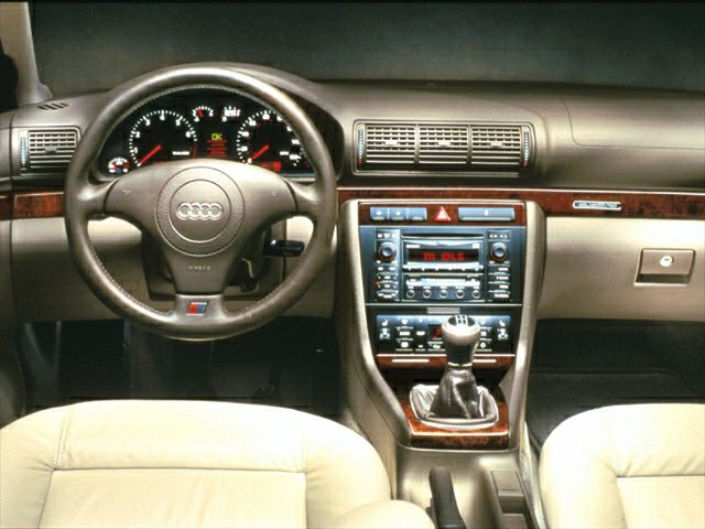 Audi interior dashboard with steering wheel and manual gearshift
