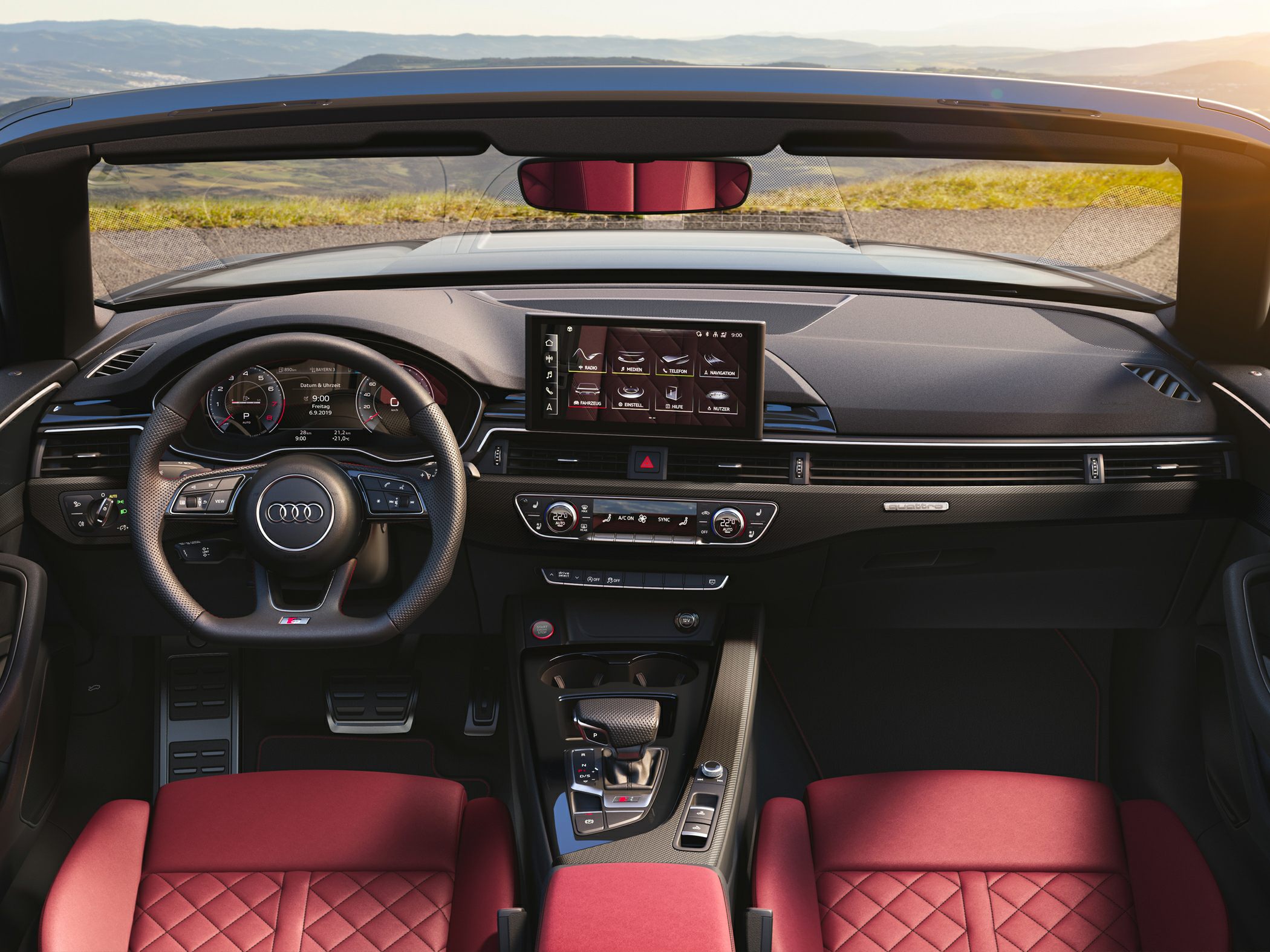 Modern car interior with digital dashboard and red quilted leather seats