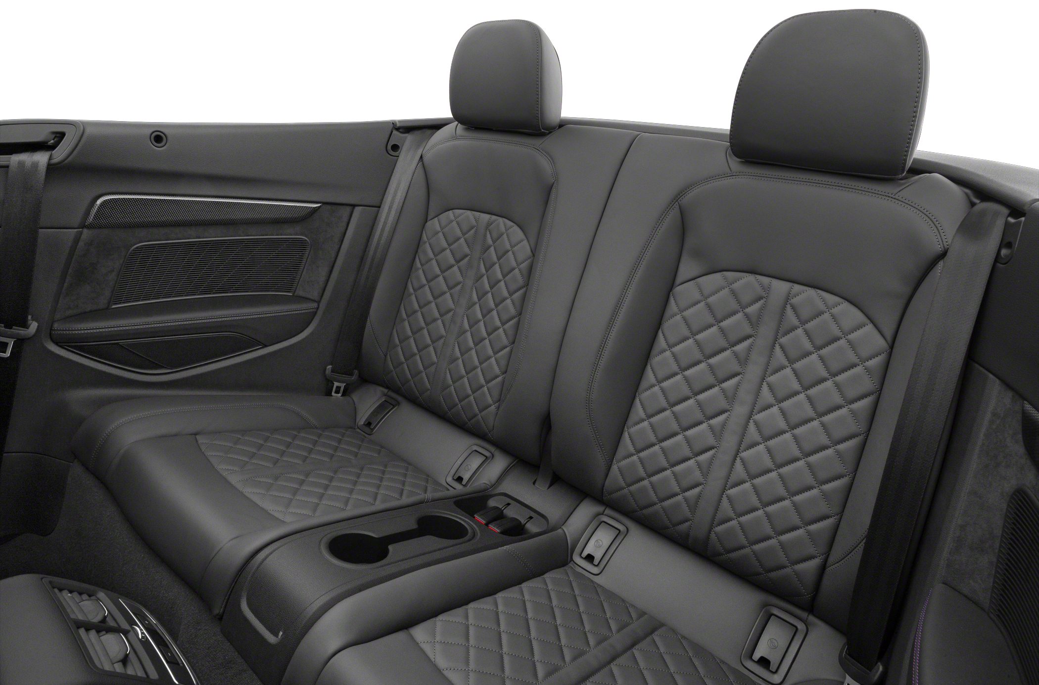 Rear leather seats with diamond stitching and integrated headrests.