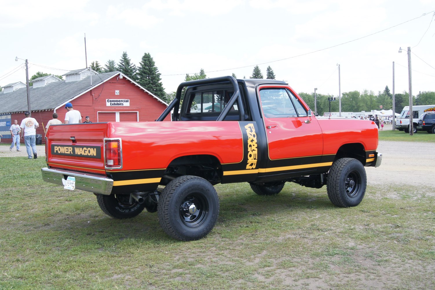 Red pickup with Power Wagon decals, black roll bar, and off-road tires