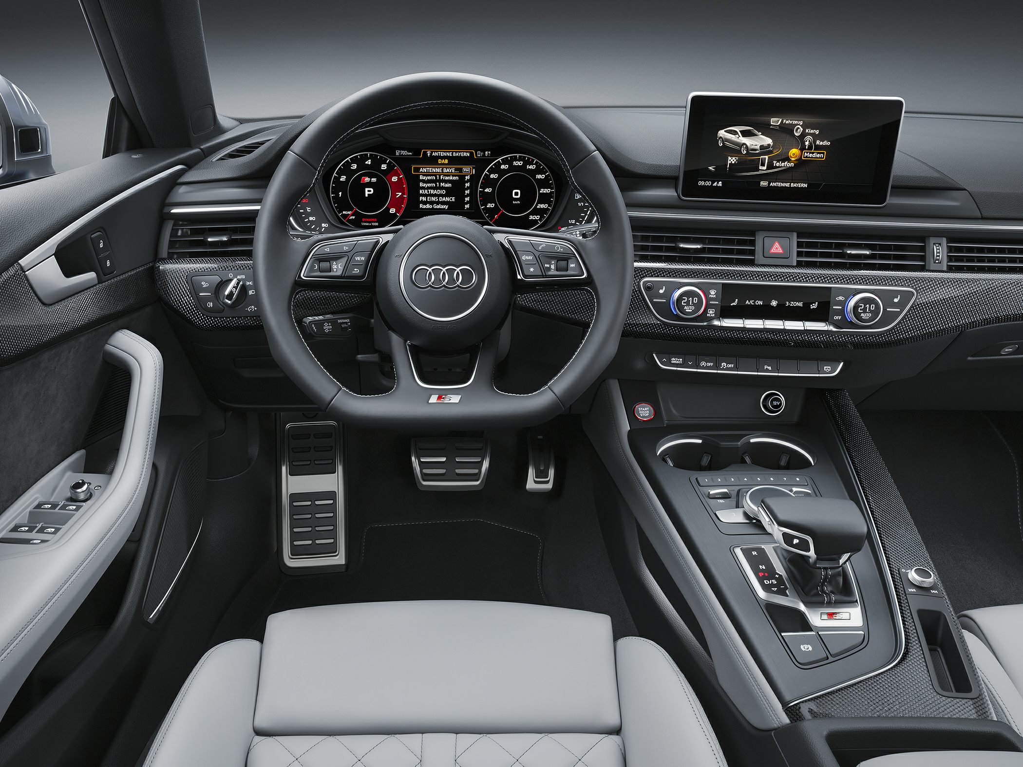 Digital instrument cluster and modern infotainment system with sport steering wheel.